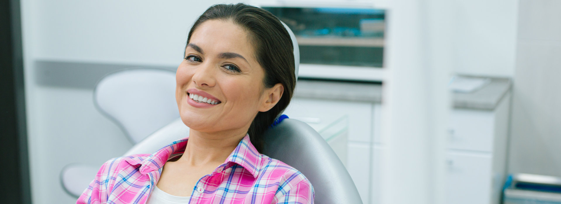 A beautiful woman is smiling after teeth whitening.