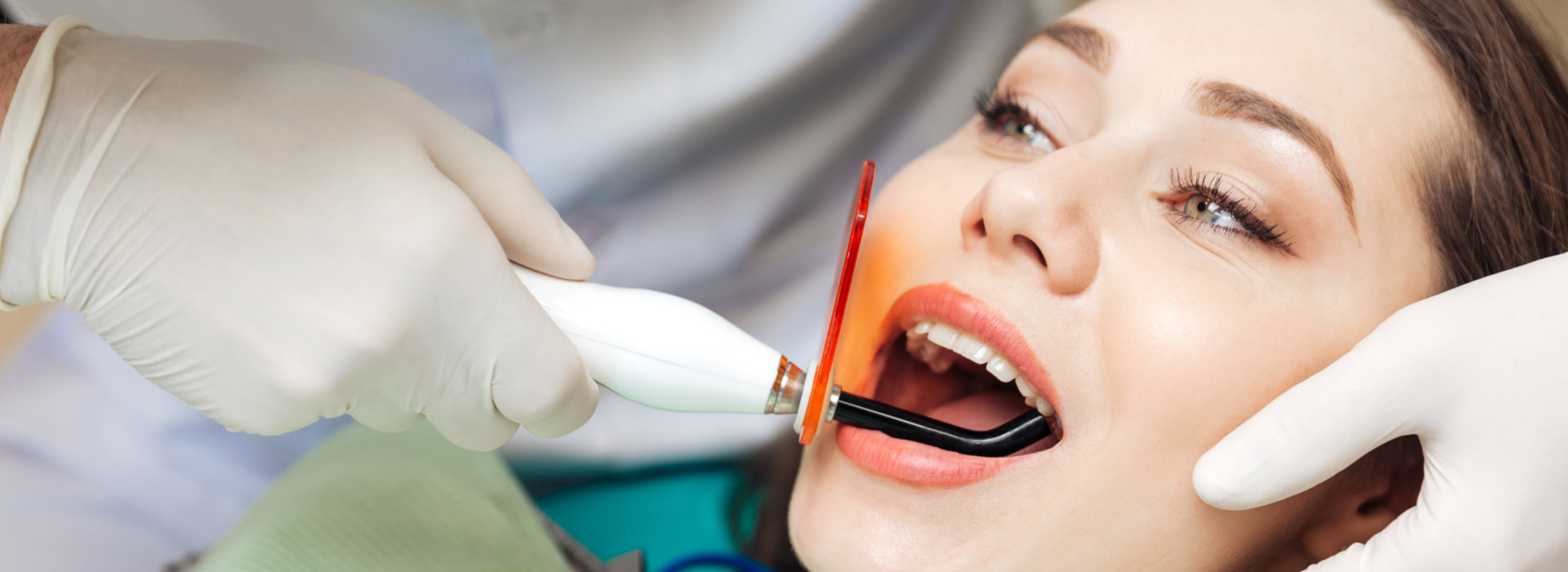 A woman is having laser dentistry.