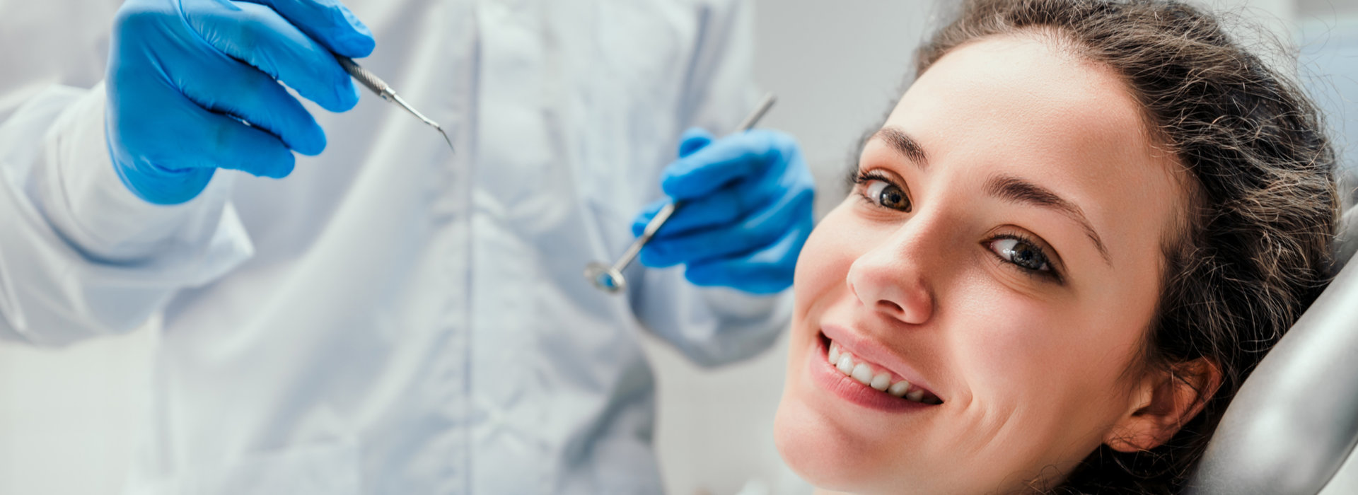 A woman is smiling after tooth extraction.